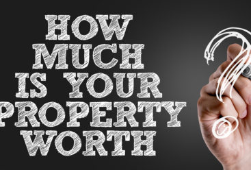 Hand writing the text: How Much Is Your Property Worth?
